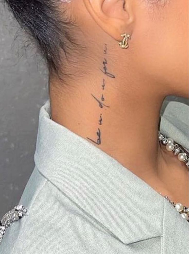 the back of a woman's neck is shown with words written in cursive writing