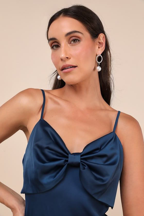 You'll look like elegant perfection the moment you step into the Lulus Extravagantly Sleek Navy Blue Satin Sleeveless Bow Midi Dress! Luxe woven satin shapes this darling dress that features adjustable spaghetti straps, a flirty V-neckline, and a sleeveless bodice with an oversized bow detail at the front and a low-cut back. The sultry, slip-style silhouette will effortlessly skim your figure as it cascades down to a chic midi hem. Hidden side zipper/clasp. Fit: This garment fits true to size. L Satin Dress For Wedding Guest During Prom Season, Elegant Sleeveless Slip Dress For Prom, Satin Finish Sleeveless Dress For Wedding Guest, Sleeveless Satin Finish Dress For Prom, Satin Sleeveless Bridesmaid Dress For Prom Season, Satin Sleeveless Bridesmaid Dress For Prom, Formal Sleeveless Dress With Spaghetti Straps For Prom, Sleeveless Satin Dress For Prom, Sleeveless Slip Dress For Wedding And Prom Season