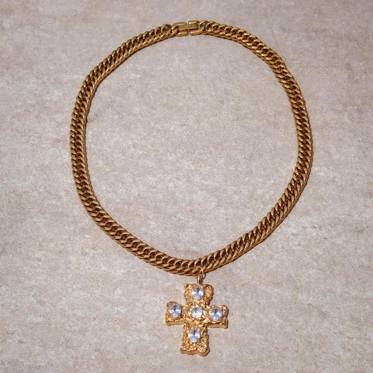 Introducing the “Adorned Cross Necklace” from the exclusive Solstress “Favored” collection. This bold, handcrafted piece features an 18” 18k gold chain that exudes strength and elegance. At its center, a prominent gold statement cross is embedded with vibrant diamond stones, creating a dazzling focal point. Perfect for making a striking impression, the Adorned Cross Necklace combines luxurious craftsmanship with timeless design, making it a standout addition to your jewelry collection. Gold Plated Cross Pendant Necklace With Gold Chain, Gold Chain Jewelry With Cross Pendant, Luxury Cross Jewelry With Adjustable Chain, Elegant Gold Cross Necklace With Chain, Vintage Cross Pendant Jewelry With Adjustable Chain, Gold Cross Pendant Chain Jewelry, Gold Plated Cross Chain Necklace, Yellow Gold Cross Chain Jewelry, Luxury Cross Pendant Jewelry With Adjustable Chain