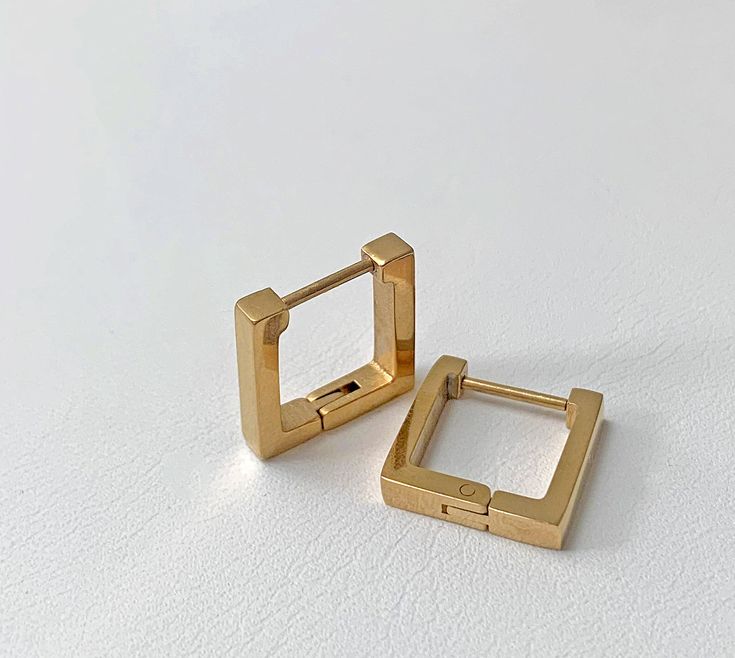 18K GOLD PLATED SQUARE HUGGIE EARRINGS Materials: Stainless steel, 18K gold plated Measurements: 0.5" X 0.5" Closure: Latch back Additional Info: Hypoallergenic: Nickel free High polish finish Eco-friendly: We use sustainable metals and recycled gold Tarnish resistant and waterproof All of our gold jewelry is plated with recycled gold. Each piece is coated using the highest grade technique, which is made to be more 8 times more durable than traditional gold-plated jewelry. Waterproof Jewelry, Sustainable Jewelry, Sample Sale, Huggie Earrings, Metal Pins, Recycled Gold, Everyday Jewelry, Beauty Accessories, Brie