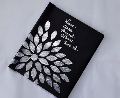 a black and white card with silver foil on it