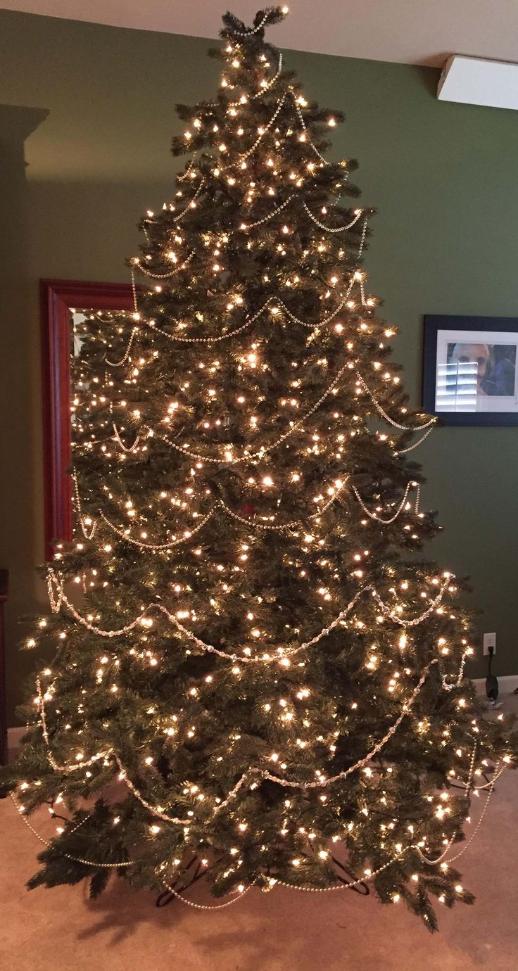 a christmas tree is lit up and ready to be put in the living room or bedroom