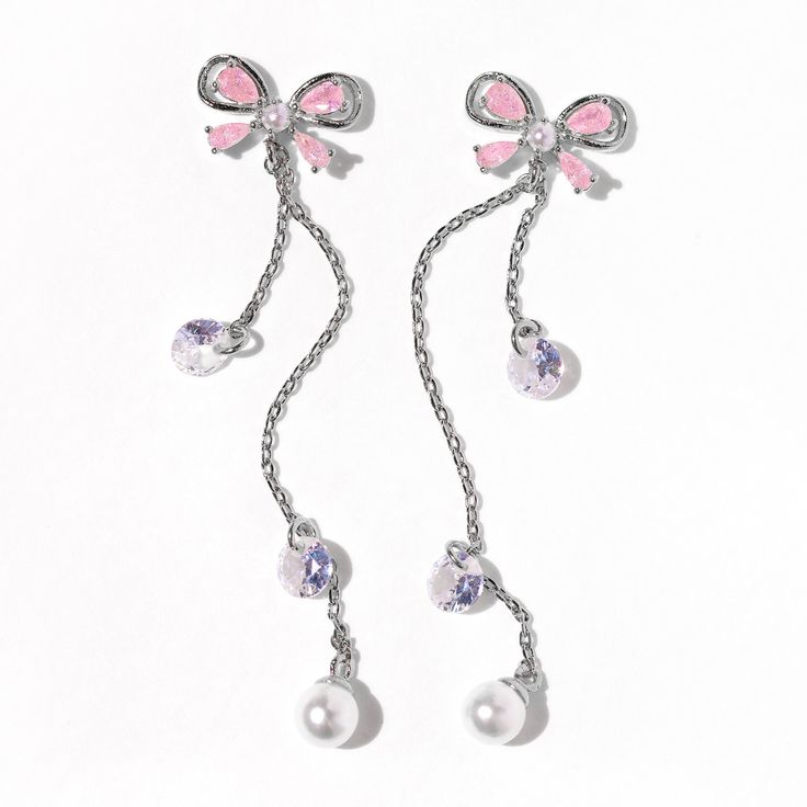 Now this is what dreams are made of. Our Princess Pearl Earrings completely embody Girls Crew’s design aesthetic you have all fallen in love with over the last six years. Are you as obsessed with the ribbon design as we are? We’ve combined baby pink CZ stones in the shape of delicate bows, pearls, and delicate “droplets.” Pink Ribbon Jewelry As Gift, Pink Ribbon Jewelry Gift, Pink Ribbon Jewelry For Gifts, Party Jewelry With Pink Bow In White, White Jewelry With Pink Bow For Party, White Party Jewelry With Pink Bow, Elegant White Jewelry With Pink Bow, Pink Cubic Zirconia Crystal Earrings, Feminine Party Jewelry With Ribbon Detail