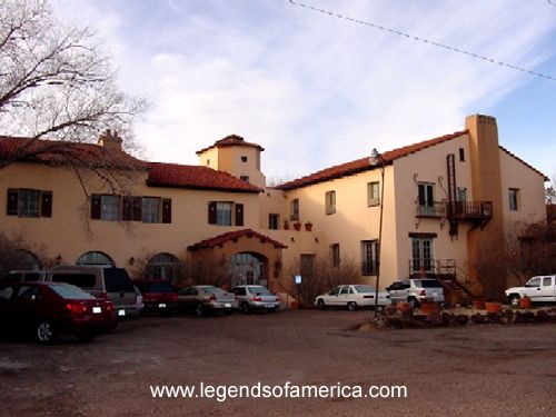 a large building with cars parked in front of it