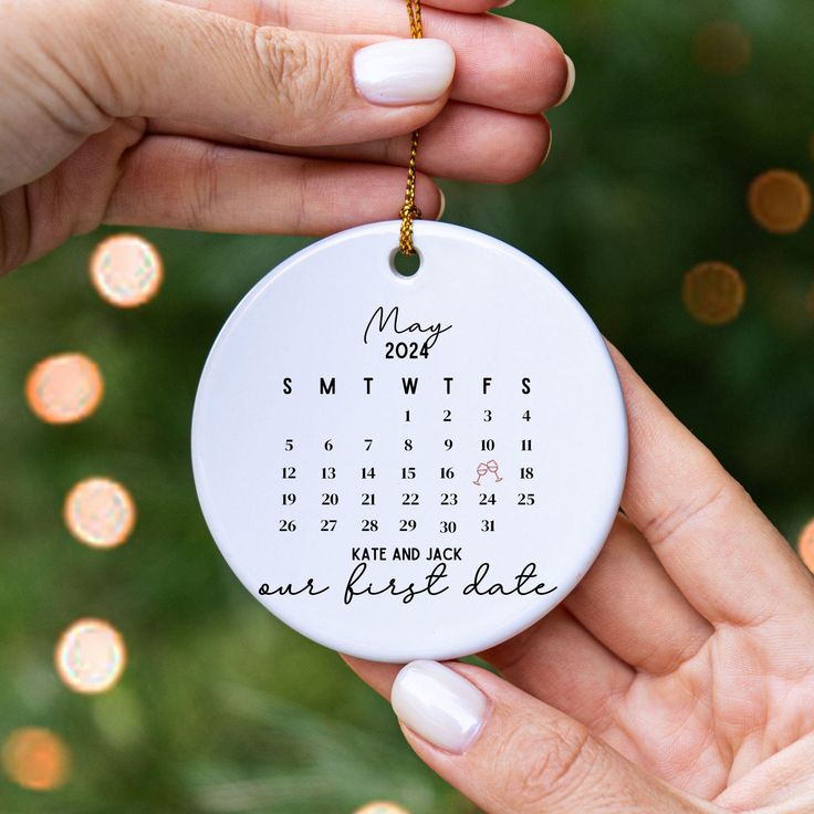 two hands holding a personalized ornament for someone's 2012 year dated calendar