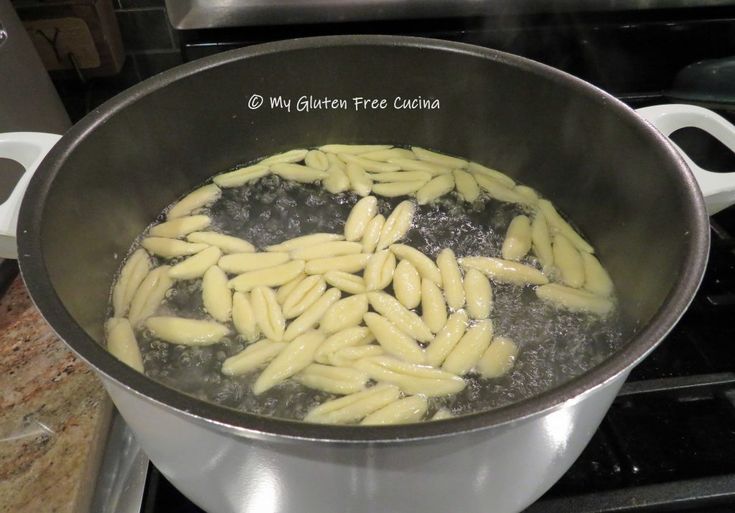 pasta being cooked in a pot on the stove