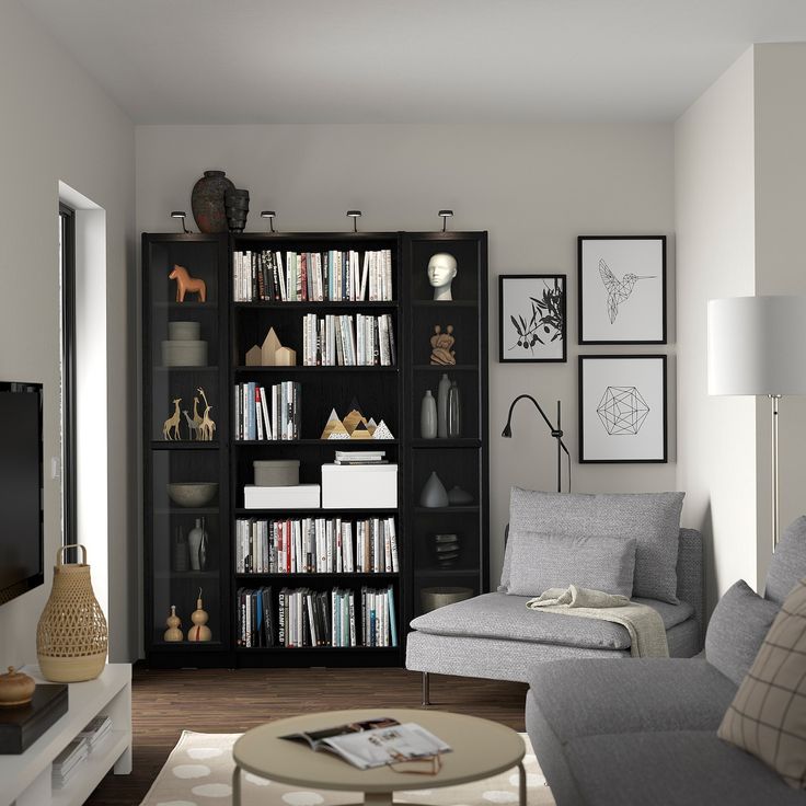 a living room filled with furniture and bookshelves next to a flat screen tv