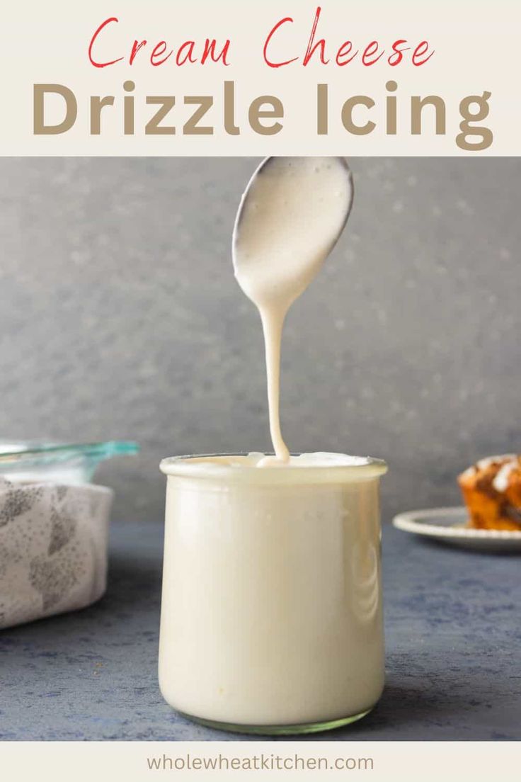 cream cheese drizzle icing is being poured into a glass jar with cookies in the background