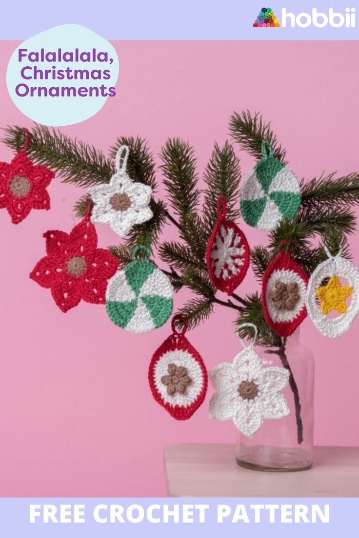 a crocheted christmas ornament hanging from a tree branch in a vase