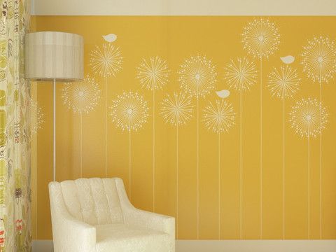 a living room with a white chair and yellow wall painted in the style of dandelions