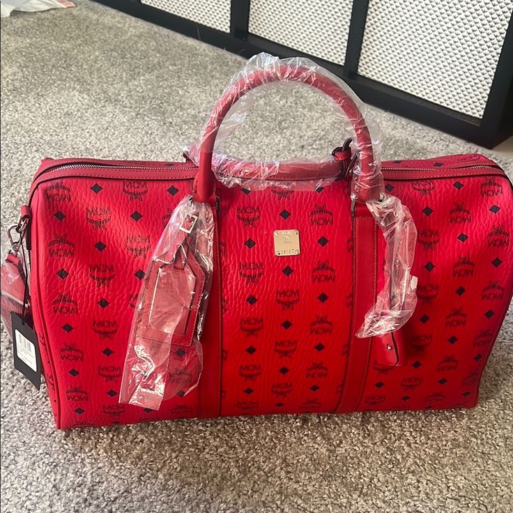 * Christmas Themed * Stay Stylish On Your Travels With This Red Duffel Bag Featuring The Iconic Mcm Logo Pattern. Perfect For Carrying All Your Essentials While On The Go. #Discounted #Mcm Designer Large Capacity Red Shoulder Bag, Designer Red Shoulder Bag With Large Capacity, Red Luxury Shoulder Bag For Daily Use, Luxury Large Capacity Red Shoulder Bag, Luxury Red Bags For Daily Use, High-end Red Shopping Bag, Designer Red Rectangular Shoulder Bag, High-end Red Bag With Removable Pouch, Luxury Red Shoulder Bag With Removable Pouch