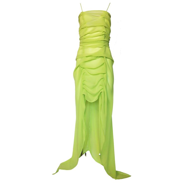 ONE OF A KIND An organically hand draped dress, in a sheer green silk fabric, allows for beautiful ruching. The original technique used with each stitch done by hand boasts beautiful gatherings that can be easily transformed to the length and amount of ruching you want on the front. The bungee cord spaghetti straps run all the way down the princess seams and hang to the floor for a subtle sporty element. With stitched ruching at the zipper seams it forms a beautiful shape to hug the curves of your body. Wear this luxurious, flowy gown for a bold and daring, yet pretty look. You can dress this up for a wedding, parties, date-night and more, or dress it down for a street-style statement. Pairs well with a black body suit or undergarments of your choice. 100% Silk Hand Wash Recommended Machin Fitted Green Maxi Dress With Ruched Bodice, Green Ruched Evening Maxi Dress, Pre-draped Green Ruched Dress, Green Draped Silk Maxi Dress, Green Draped Evening Maxi Dress, Green Draped Silk Dress, Green Ruched Back Evening Dress, Green Evening Dress With Ruched Back, Green Pre-draped Maxi Dress