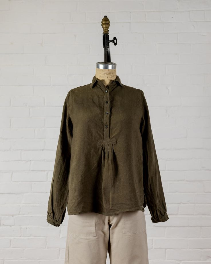 Long sleeve top with a small collar to wear up or down, mother of pearl button front and cuffs. Small gather at bottom of button front. Easy to wear on it's own, or layered under another top, jacket or sweater.  100% Linen. Made in the U.S.A. All of our pieces have been pre washed and dried to minimize any shrinkage. W Blouse With Buttons And Fold Down Collar, Winter Cotton Blouse With Buttons, Fall Blouse With Fold Down Collar And Relaxed Fit, Relaxed Fit Blouse With Fold Down Collar For Fall, Long Sleeve Linen Tops For Layering, Fall Relaxed Fit Blouse With Fold Down Collar, Long Sleeve Blouse For Fall Daywear, Long Sleeve Blouse For Daywear In Fall, Relaxed Fit Blouse With Cuffed Sleeves For Fall