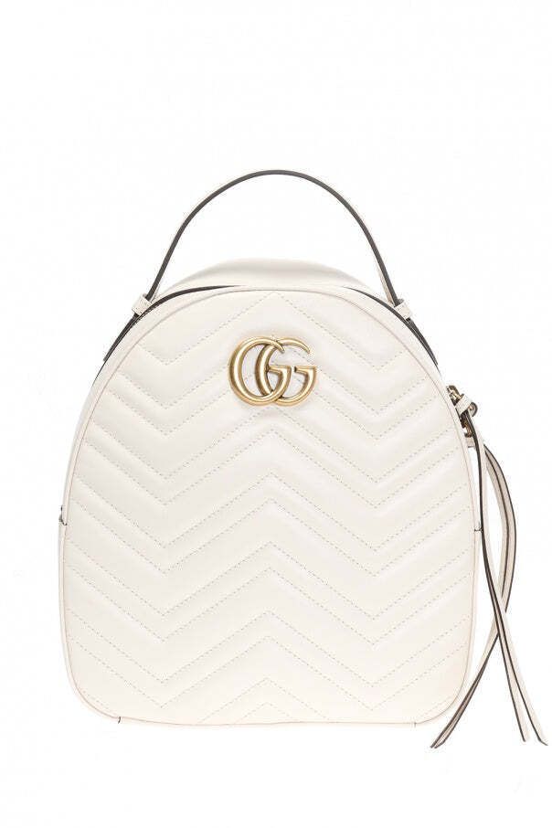 Gucci Marmont White Mystic Backpack GG Leather Italy Bag Authentic NEW 476671 DTDHT 9022 Cream 'GG Marmont' quilted backpack from Gucci. Made of leather. Fastened with zip. Metal logo at front. Semi-round handle. Adjustable shoulder straps. Beige suede, lined interior with 2 slip pockets. Antiqued gold-tone metal hardware. Height: 25,5cm Width: 23,5cm Model's Measurements Height: 176cm Bust: 85cm Waist: 60cm Hips: 89cm Made in Italy. Certificate of authenticity, tags, Controllo cards, dust bag. Gucci Marmont White, Gucci Backpack, Handbag Boutique, Round Handle, Quilted Backpack, Gucci Marmont, Gucci Gg Marmont, Chevron Quilt, Gg Marmont