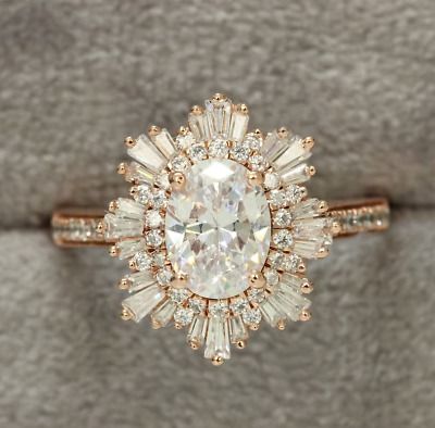 an engagement ring with a large diamond surrounded by smaller diamonds