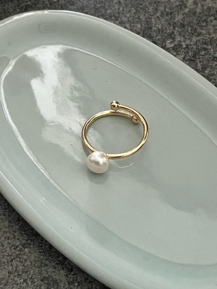 18k gold natural freshwater ring, this style is very simple and generous, it is very suitable for wearing at work and study or dating. The small, very shiny pearls are understated and luxurious. ■ DETAILS * Size: Adjustable * Colour: Gold * Material: 100% Freshwater Pearl, 18K Gold Plated Material * Each natural freshwater pearl is unique, their size and shape might vary slightly. ■ JEWELRIES CARE * Don't expose your jewellery to harsh chemicals, make-up or soaps. We recommend taking your jewell Minimalist Everyday Yellow Gold Pearl Ring, Everyday Minimalist Yellow Gold Pearl Ring, Gold Everyday Pearl Ring With Pearl Drop, Everyday Gold Pearl Drop Ring, Minimalist Everyday Rings With Pearl Drop, Everyday Gold Pearl Ring With Pearl Drop, Minimalist Pearl Drop Ring For Everyday, Minimalist Everyday Pearl Ring With Charm, Minimalist Everyday Pearl Drop Ring