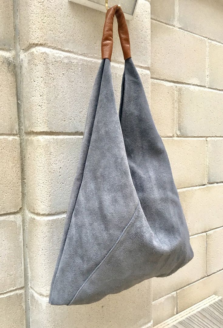 LARGE tote leather bag in GRAY. Slouch bag in genuine SUEDE leather. NOT LINED.  We added  a small leather zipper pouch for your mobile phone and/or cards or money.  It ist attached to the inside of the bag with a piece of suede in the same green color. Genuine leather accent shoulder piece in camel brown.  This listing is for the bag in GRAY , also available in green and  beige.  The bag is closed with suede bands, no zipper.  Width at the base : 43 cm - 17 in Height at the center, without the Luxury Canvas Hobo Bag With Removable Pouch, Luxury Suede Bags For On-the-go, Slouch Handbag Purses, Modern Rectangular Suede Hobo Bag, Modern Suede Hobo Bag With Double Handle, Modern Double Handle Suede Hobo Bag, Modern Hobo Bag With Suede Lining For Daily Use, Modern Hobo Bag For Daily Use With Suede Lining, Modern Suede Shoulder Bag With Removable Pouch