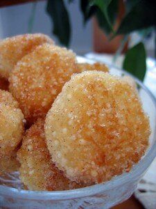 some sugar coated donuts in a glass bowl