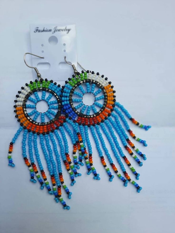 This African beaded Masai earring are made of beads which comes in different colours of ones choice. They can be warn at any given time, whether in weddings, parties, or any occasion. Note:This listing is for one pair,  but I do both wholesale and retail African Beads, Kenya, Round Beads, Clip On Earrings, Mother’s Day, Different Colors, Etsy Accessories, Jewelry Earrings, Accessory Gift