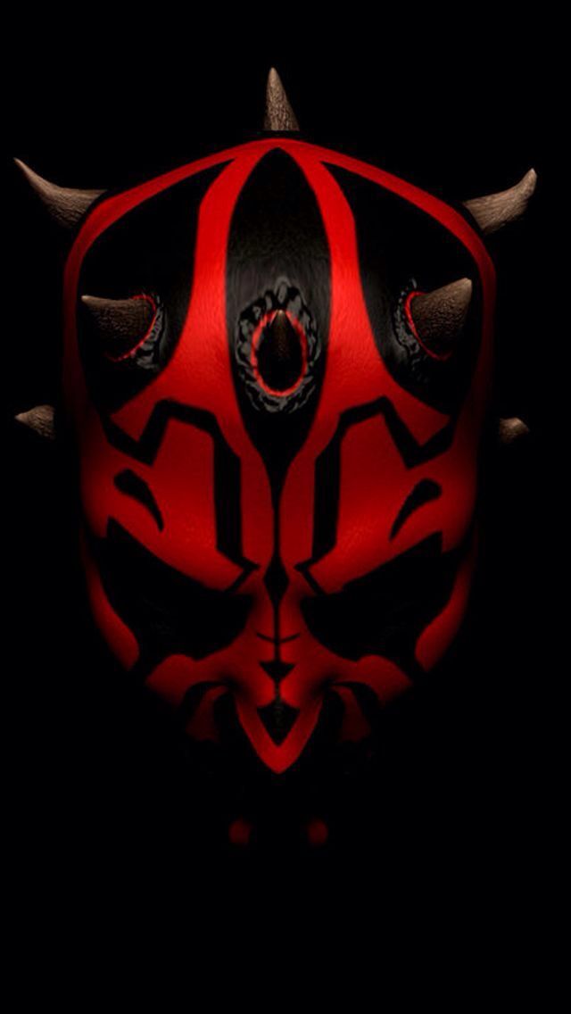 a red and black mask with horns on it's face in the dark background