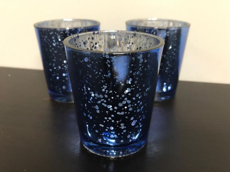 three blue glasses sitting on top of a table