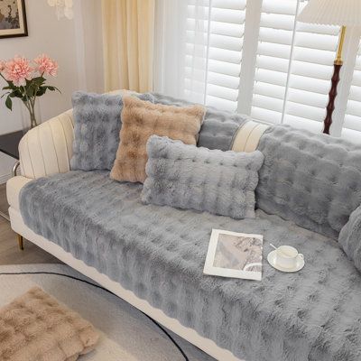 a living room filled with furniture and pillows