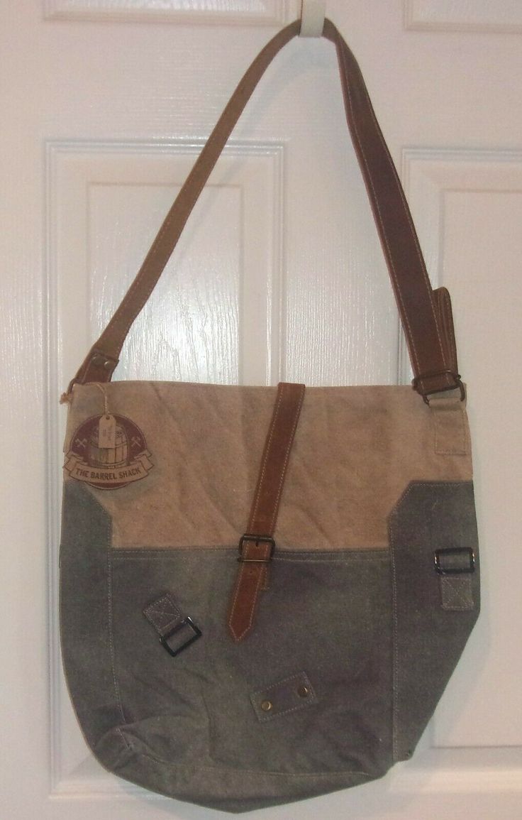 Gorgeous Handmade Shoulder Bag from The Barrel Shack! Brand new with tags. Retail $208. Height: 14" Depth: 5" Width: 15" Strap Drop: 16" The Bryant from The Barrel Shack is a handmade bag that has been crafted from vintage canvas and leather. Adjustable leather shoulder strap (16") is wide (1-1/4") and flat so it will fit comfortably on your shoulder. Closes securely with a leather strap and buckle on the front. Combination of textures, patches, leather, and two-toned canvas creates a vintage-lo Square Canvas Satchel For School, Square Canvas Shoulder Bag With Adjustable Strap, Retro Backpack For Everyday Use, School Canvas Shoulder Bag With Leather Handles, Rectangular Hobo Bag With Leather Trim, Leather Handle Tote Satchel For School, Retro Hobo Bag With Adjustable Strap For Everyday, Leather-handled Satchel Tote For School, School Satchel With Leather Handles And Canvas Material