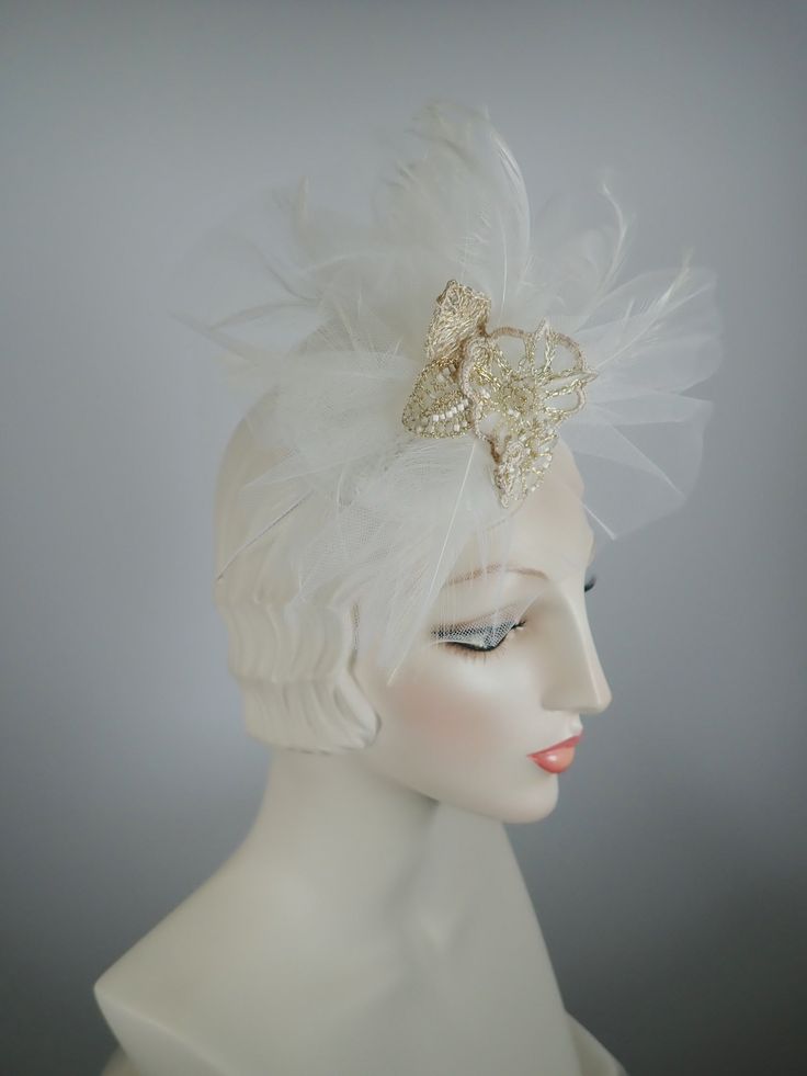 An elegant off-white fascinator perfect for a non-traditional wedding headpiece. It contains something old (vintage lace), something new (wire floral flower), and something blue (lining). The circular button base is covered in vintage white lace and then is topped with veiling, feathers and a gorgeous hand crocheted wire, bead and fabric flower grouping. Mounted on a narrow elastic band to help keep it in place. Upon request, I can remove the elastic band and mount it on a narrow headband. Beaut Elegant Tulle Mini Hats For Wedding, Adjustable Tulle Fascinator For Wedding, Fitted White Headpiece With Handmade Flowers, Adjustable Tulle Wedding Fascinator, Elegant Fitted Tulle Fascinator, Elegant Evening Tulle Headpieces, Elegant Cream Party Veil, Vintage Evening Fascinator Headband, White Formal Headpiece With Handmade Flowers