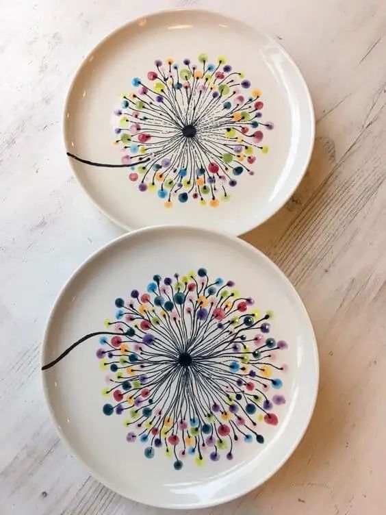 two white plates with colorful designs on them