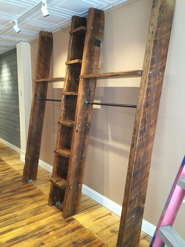 ladders are lined up against the wall in an empty room with hard wood flooring