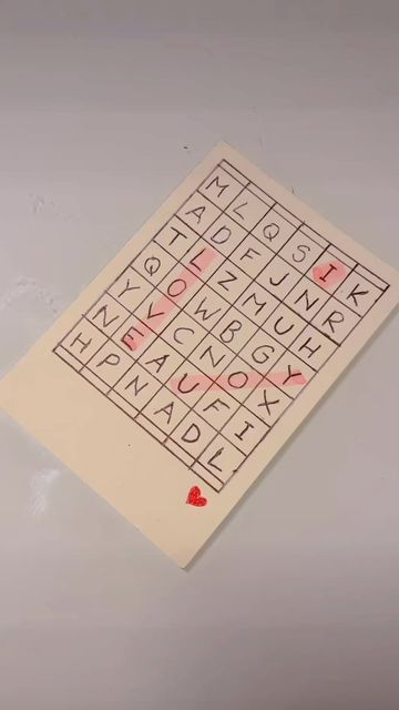 a piece of paper that has some type of writing on it with red hearts in the middle