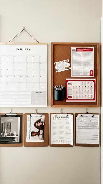 a bulletin board with calendars hanging on the wall