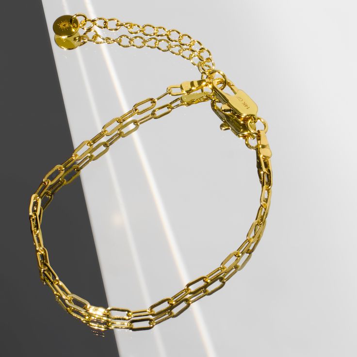 Our Paperclip bracelet is a golden staple to wear alone or stack with our other gold filled bracelets. Our 14k gold-filled jewelry is bonded with 14k gold and is water and tarnish resistant. 14k gold-filled jewelry is a great alternative to solid gold, and can be worn by people with sensitive skin. The color will not tarnish but recommend to keep away from perfumes and lotions. - 14k gold-filled- Chain width: 3.5 mm.- Chain length: 6"- Water resistant / Tarnish resistant / Hypoallergenic Tarnish Resistant Gold Double Band Jewelry, Tarnish-resistant Gold Double Band Jewelry, Gold Tarnish-resistant Double Band Jewelry, Gold Link Paperclip Bracelet, Tarnish Resistant, Gold Plated Bracelets With Paperclip Chain, Gold Plated Minimalist Paperclip Bracelet, Tarnish Resistant Gold Link Paperclip Bracelet, Adjustable Gold-tone Paperclip Bracelet For Everyday, Tarnish Resistant Gold Paperclip Link Bracelet