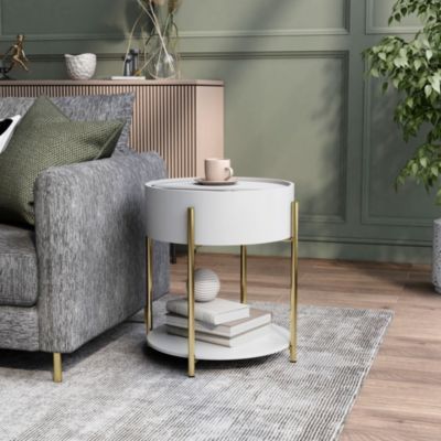 a living room with a couch, table and potted plant on the sideboard