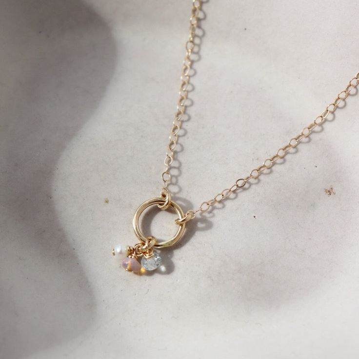 Embrace eternal love with our 14k gold Birthstone Necklace. Featuring a never-ending circle adorned with faceted birthstones, this delicate keepsake is the perfect gift for mothers or grandmothers. A symbol of love that you can cherish forever. DETAILS14k Solid GoldAvailable in 16" or 18" Anniversary Birthstone Necklace With Round Pendant And Delicate Chain, Delicate Birthstone Necklace For Anniversary, 14k Gold Round Pendant Birthstone Necklace For Wedding, Dainty 14k Gold Charm Necklaces For Anniversary, Delicate Gold Birthstone Necklace In Sterling Silver, Briolette Birthstone Necklace For Anniversary, 14k Gold Round Birthstone Jewelry, 14k Gold Birthstone Necklace For Wedding, Dainty Birthstone Necklace With Charms