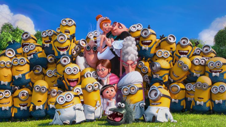 a group of people standing in front of a bunch of minion characters with their mouths open