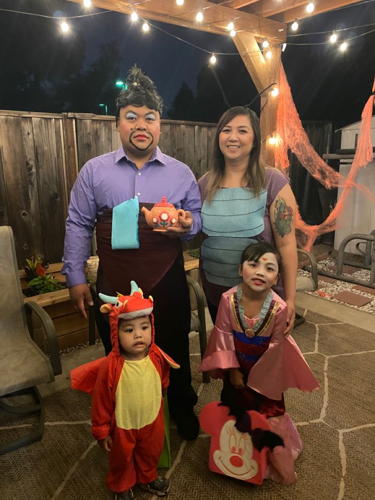 two adults and one child dressed up in costumes