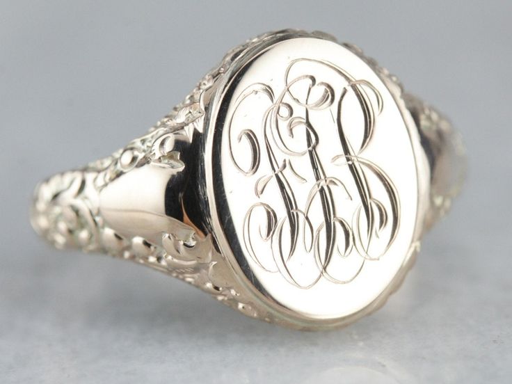 "We've created this lovely ornate piece, from two antique components creating one lovely statement piece! An antique oval top with scrolling \"FGB\" initials in French script has been soldered atop an antique mounting with ornate motifs along its shoulders. The lovely monogram of this signet ring is so beautifully engraved and entwined that it makes a lovely image, regardless of their initials! Please note that this signet ring has its original monogram, unfortunately, this piece cannot be alter Yellow Gold Sapphire Ring, 10 Marks, French Script, Gold Statement Ring, Top Measurements, Cameo Ring, Gold Signet Ring, Gold Top, Unisex Ring