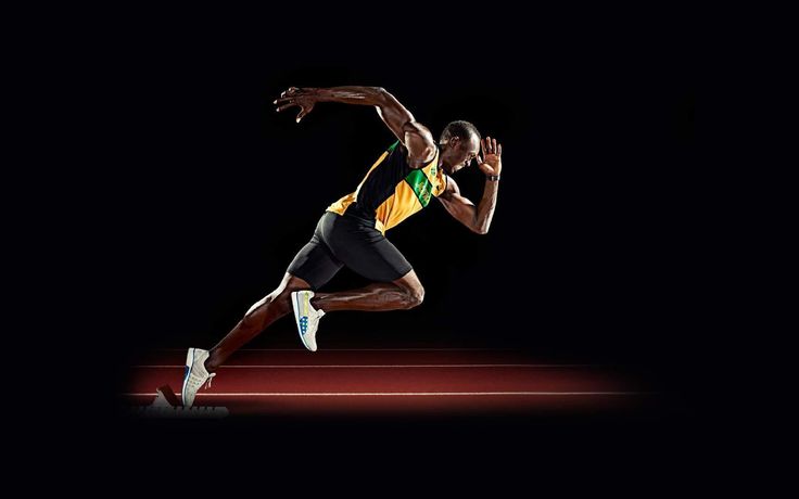 a man is running on a dark background