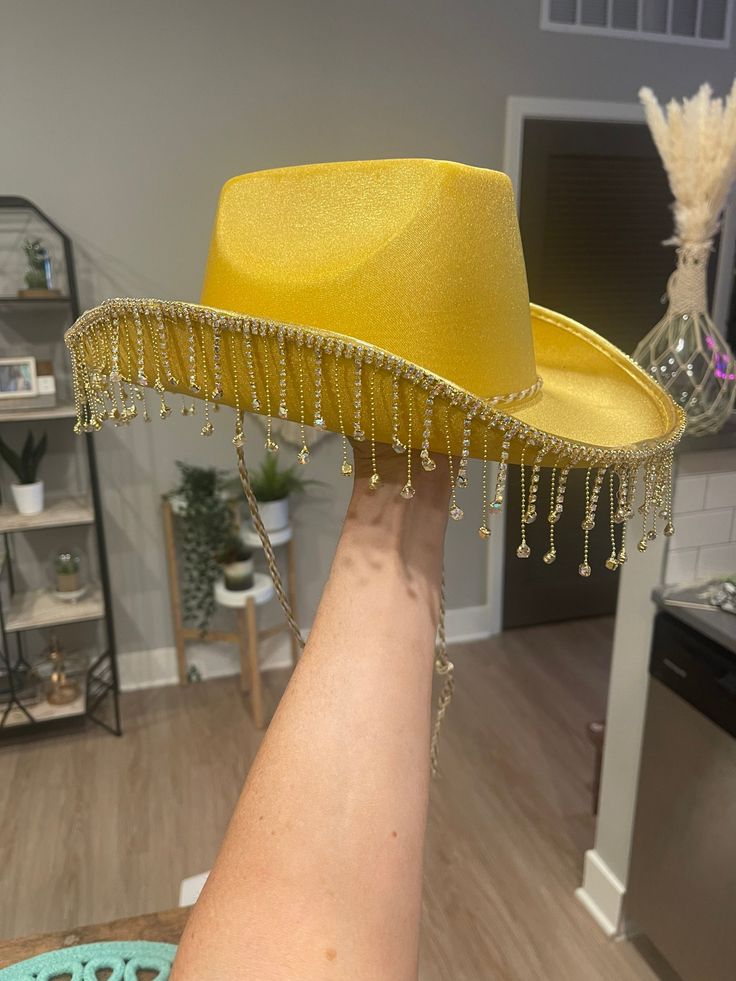 Super cute gold cowboy hat with gold jewel fringe Gold Fedora For Kentucky Derby, Gold Wide Brim Hat For Festivals, Gold Wide Brim Festival Hat, Gold Brimmed Hat For Rodeo, Gold Fedora Hat For Rodeo, Western Gold Brimmed Hat, Gold Western Fedora Hat, Gold Fedora Hat For Festival, Gold Wide Brim Costume Hat For Parties