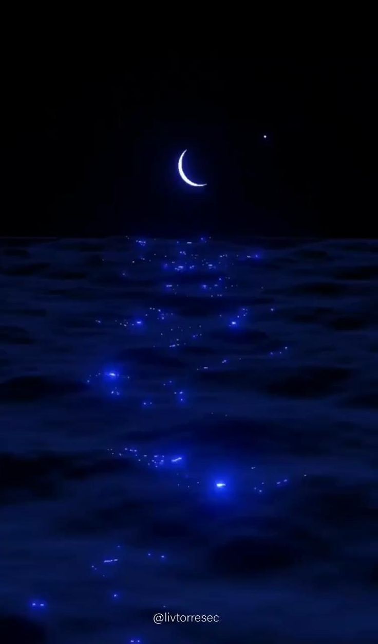 the moon is shining in the night sky above the water with stars and lights on it