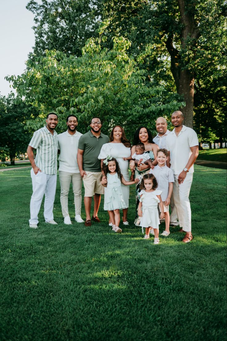 a family posing for a photo in the grass