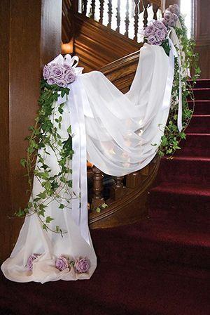 the stairs are decorated with flowers and greenery