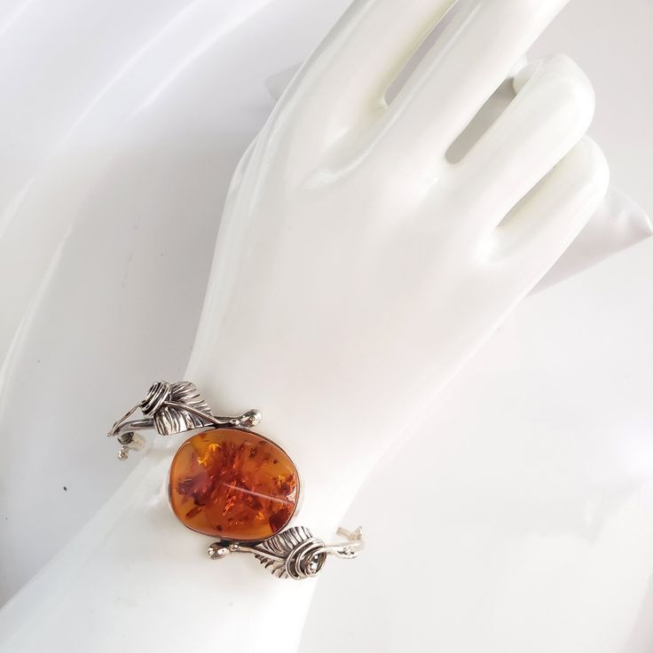 beautiful amber silver cuff bracelet Unique Silver Baltic Amber Jewelry, Vintage Amber Bangle Jewelry, Vintage Baltic Amber Jewelry For Formal Occasions, Classic Handmade Jewelry In Baltic Amber, Classic Cabochon Bracelets As Gift, Classic Cabochon Bracelets For Gifts, Amber Bangle Jewelry For Gift, Handmade Adjustable Baltic Amber Jewelry, Adjustable Amber Jewelry With Polished Finish