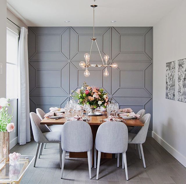 a dining room table is set with flowers and place settings for four people to eat