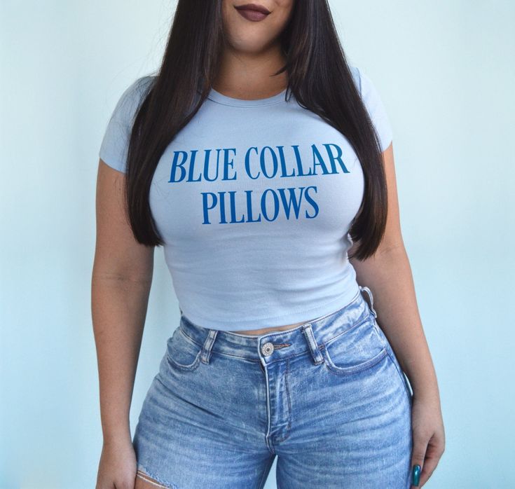 Blue collar pillows baby tee. *Model is a size 6 and wearing a medium.* BABY TEE - 52% cotton / 48% polyester - Bella + Canvas brand - Micro ribbed material - Form fitting but has lots of stretch Cute Fitted Blue T-shirt, Fitted Blue Slogan T-shirt, Fitted Blue T-shirt With Slogan, Blue Fitted Slogan T-shirt, Blue Fitted T-shirt With Slogan, Trendy Blue Slogan Top, Blue Cotton Slogan Top, Fitted Blue T-shirt With Text Print, Fitted Light Blue Tops With Letter Print