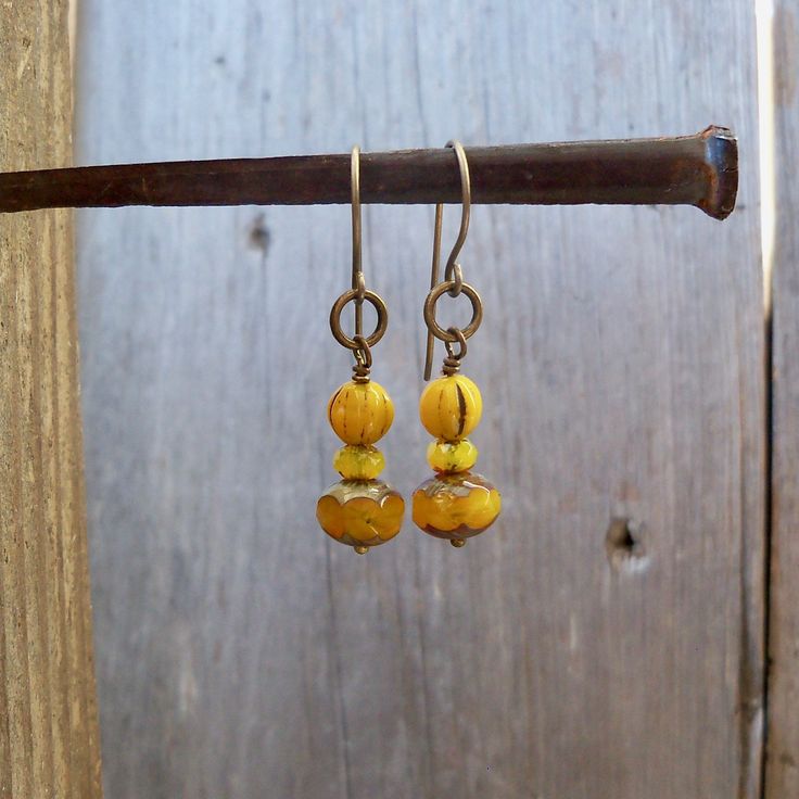 I have been seeing mustard yellow all over lately. I have had these beads tucked away, just waiting for inspiration. These earrings are dangling from pure titanium post ear wire. Perfect for those with sensitive ears. The Czech bead is a 6mm melon bead. It has a touch of black in various places on the bead. Very vintage feel to the beads. These earrings are a perfect match to the necklace that is also listed. You can find it here. https://www.etsy.com/listing/707647612/vintage-style-mustard-yell Hypoallergenic Gold Bohemian Beaded Earrings, Nickel Free Yellow Beaded Earrings For Gift, Nickel-free Yellow Beaded Earrings As Gift, Nickel-free Yellow Beaded Earrings For Gifts, Yellow Dangle Earrings With Ear Wire, Everyday Yellow Beaded Jewelry, Yellow Beaded Czech Glass Earrings, Yellow Beaded Earrings With Czech Glass, Yellow Beaded Earrings In Czech Glass