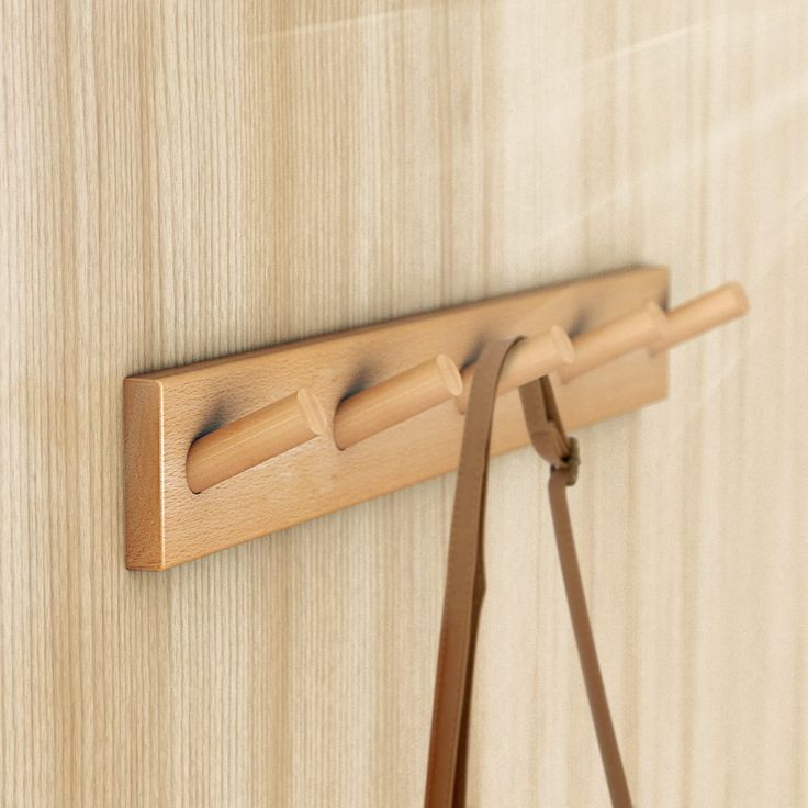 a close up of a wooden door with a leather strap hanging on the front and side