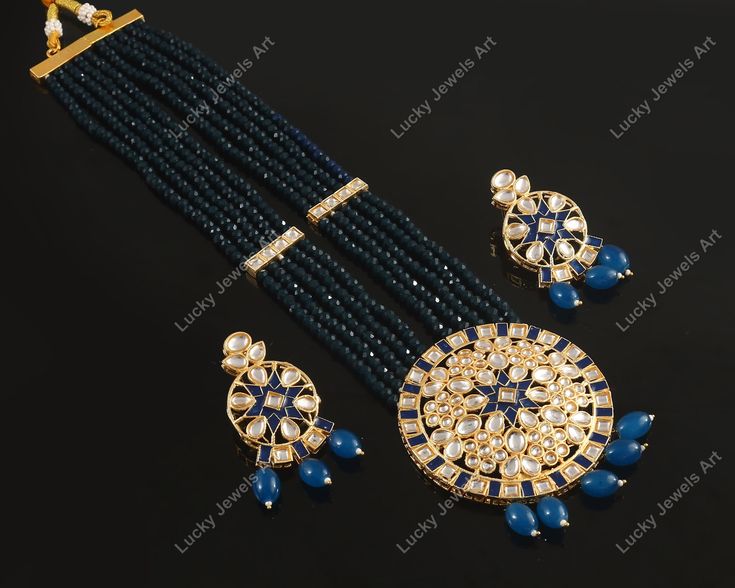 This is a stunning hand painted necklace perfect for high end Jewelry Collector, a keeper in Traditional Vintage Indian/Pakistani Bridal jewelry and a Luxury Gift for your Daughter, Sister or Wife on Wedding or Anniversary. Perfect for any type of occasions, weddings And celebrations and a beautiful & memorable gift for weddings and special occasions. -Item Code:-M73 -Rajwada Necklace Set with Earrings. -Designer multi layered blue beaded necklace with hand painted pendant. -Gold Plated Set with kundan which shine like precious stones. -Metal: Gold plated brass -Earrings are 55mm long & 28mm wide approx -Push Back Earrings -Necklace length with pendant 11" approx excluding adjustable dori/cord -Quantity:- One Necklace Set Please see more different designs here:- https://www.etsy.com/in-en/ Luxury Blue Kundan Necklace For Weddings, Blue Temple Jewelry Bridal Necklace With Meenakari, Blue Meenakari Bridal Necklace In Temple Jewelry Style, Traditional Blue Jewelry For Reception, Traditional Blue Beaded Necklaces For Celebrations, Blue Kundan Necklace With Meenakari Details, Traditional Blue Beaded Necklace For Celebrations, Blue Chandbali Bridal Necklace Gift, Blue Bridal Necklace In Temple Jewelry Style With Meenakari