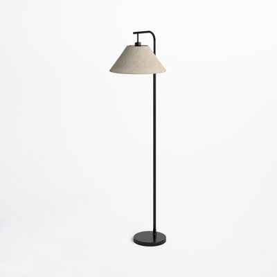 a black floor lamp with a white shade